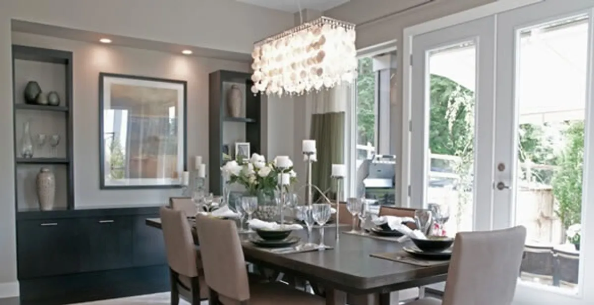 Elegant dining room chandelier installation above table in Buffalo, NY