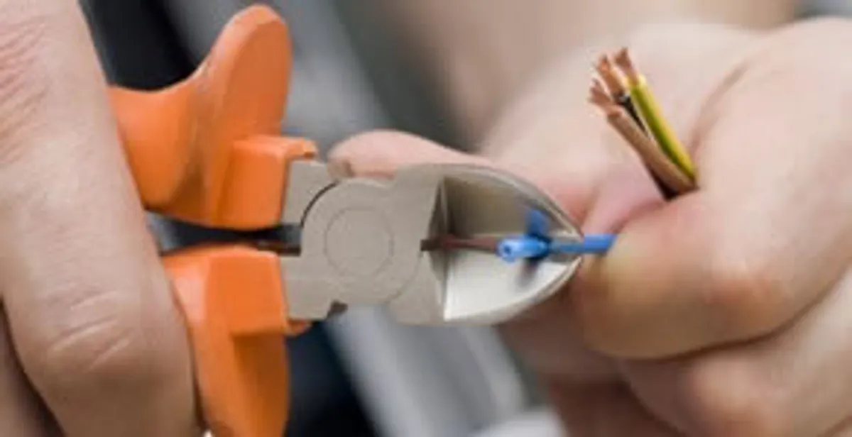 professional electrical services showing precise wire cutting by licensed electricians in Buffalo, NY